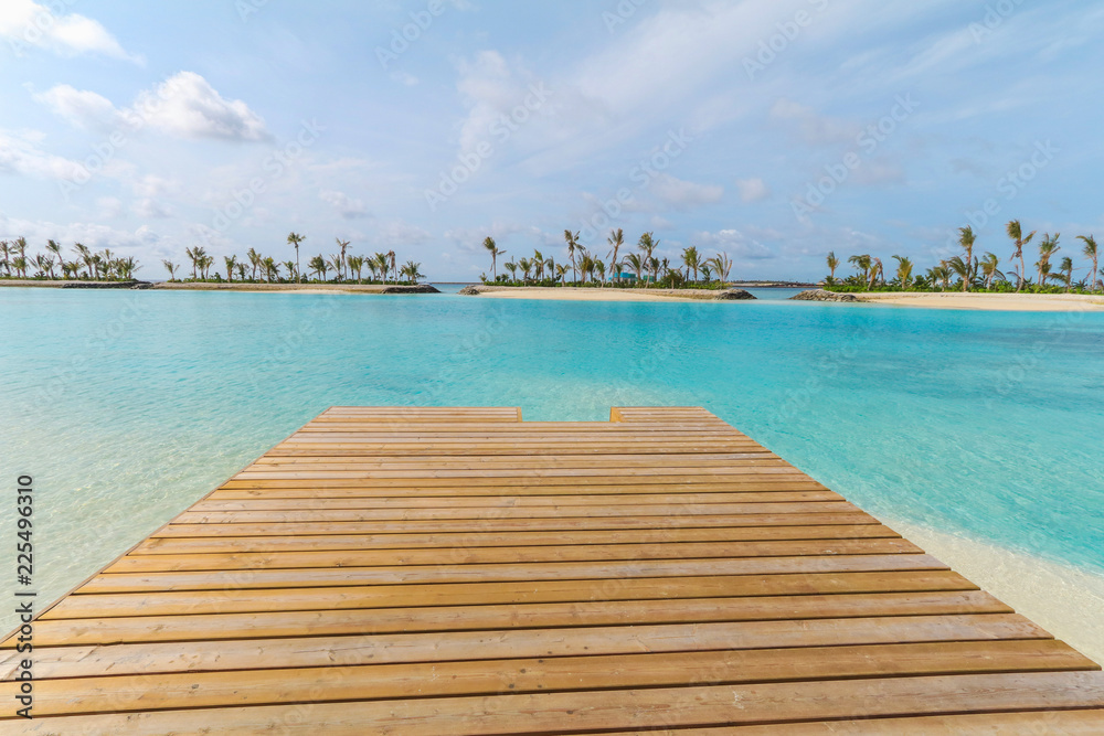 Amazing island in the Maldives ,Beautiful turquoise waters ,wooden bridge with  blue sky  background for holiday vacation .