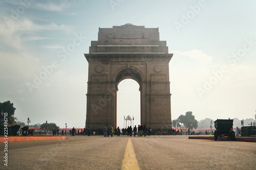 India Gate on the background of cloudy sky, Sightseeing in new Delhi. view from the road photo