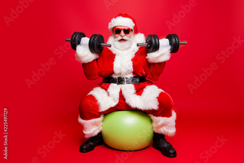 Fototapeta Naklejka Na Ścianę i Meble -  Cheerful sporty muscular virile strong Santa in white fluffy glo