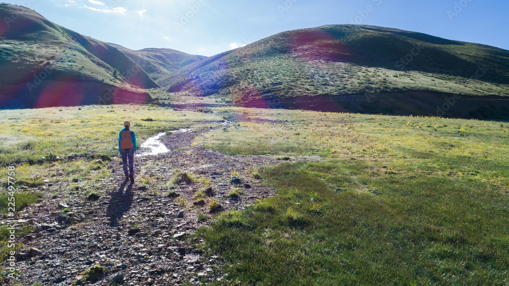 aerial view of hiker hiking in sunrise mountains