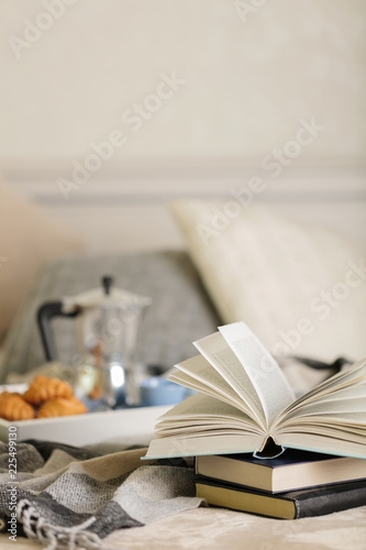 Breakfast in bed. On a white tray there is a coffee maker, coffee blue cup and croissants.