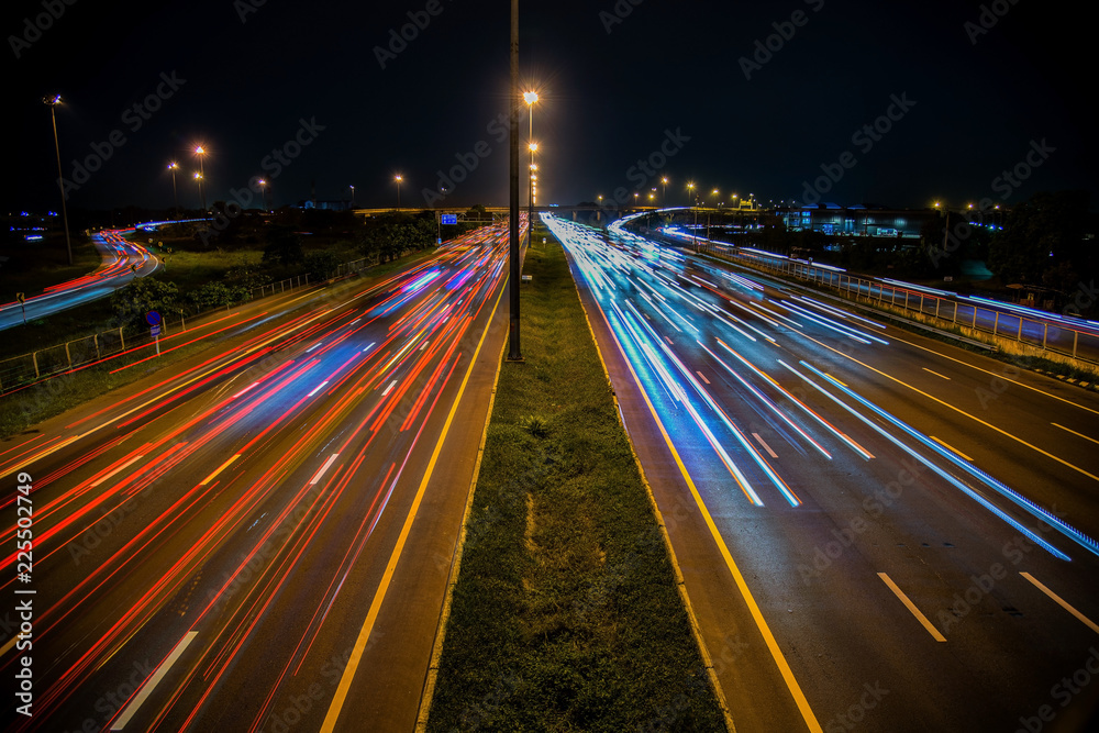 Obraz premium Speed Traffic - light trails on motorway highway at night, long exposure