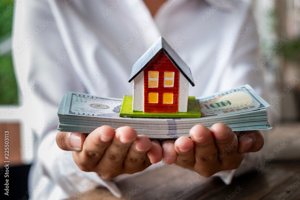 House Model And Money In Hand Concept Of Real Estate And Deal Stock House Model And Money In Hand Concept Of Real Estate And Deal Stock