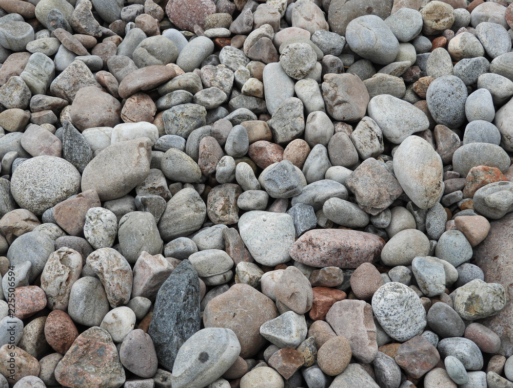 Close-up of colorful, mostly gray and reddish brown pebbles and stones Close-up of colorful, mostly gray and reddish brown pebbles and stones
