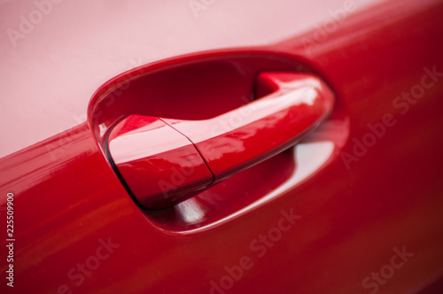 closeup of modern handle on red car