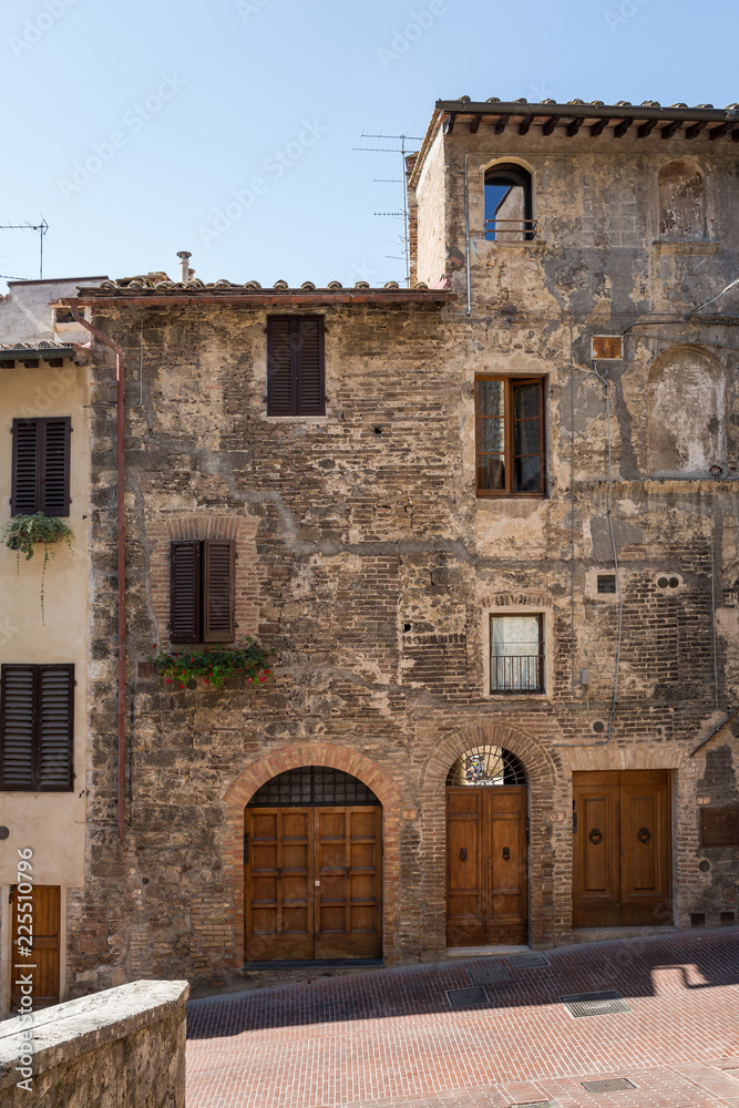 San Gimignano,  Italy July 2 2015 : Beautiful brick buildings in San Gimignano, Tuscany, Italy