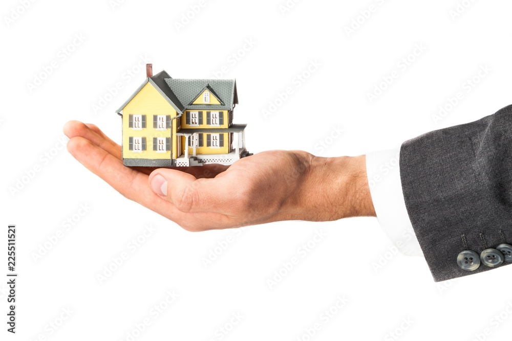Men's Hand Holding a Model of a House