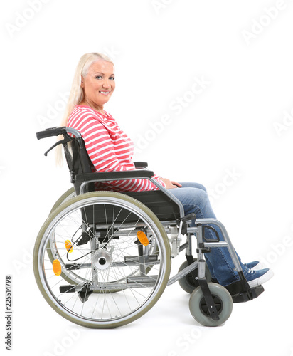 Mature woman sitting in wheelchair on white background