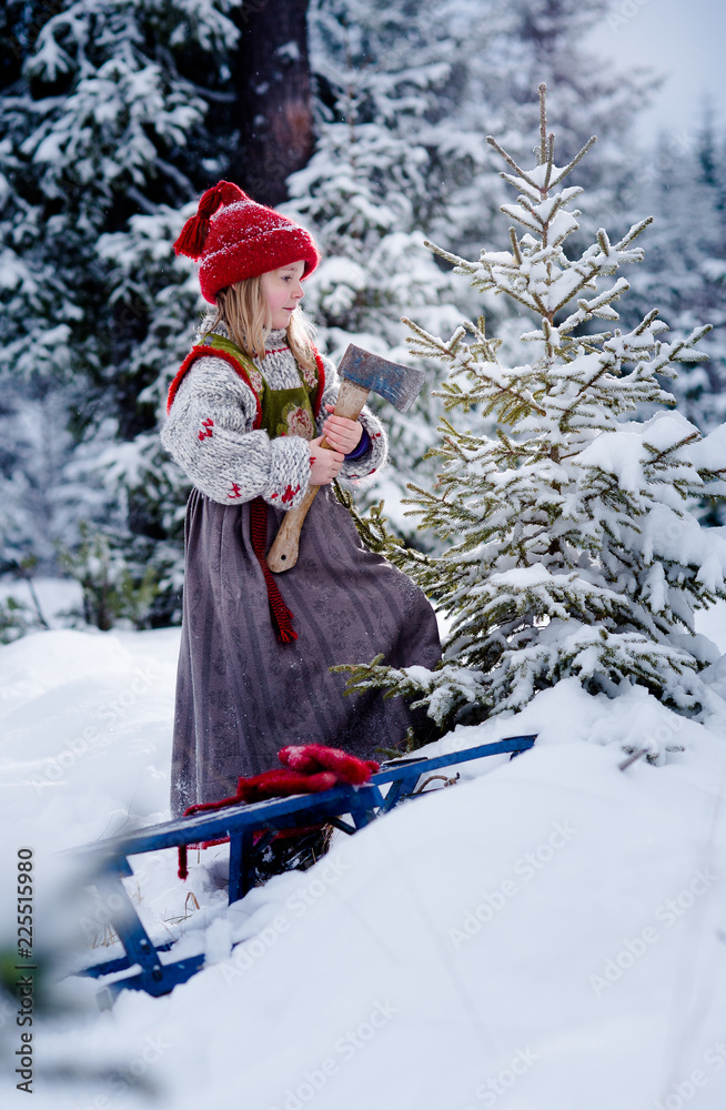 Little girl finding christmas tree in the forest in deep snow Little girl finding christmas tree in the forest in deep snow