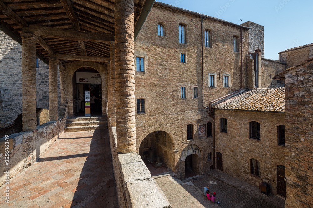 San Gimignano Italy July 2nd 2015 : Entrance and courtyard to the Musei Civici in San Gimignano, Tuscany, Italy San Gimignano Italy July 2nd 2015 : Entrance and courtyard to the Musei Civici in San Gimignano, Tuscany, Italy