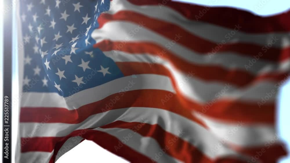 Animation of US flag blowing in the wind in slow motion, loopable American symbol against blue sky