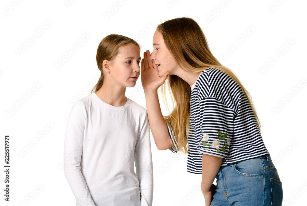 Young teen girls on white background whispering gossips Young teen girls on white background whispering gossips