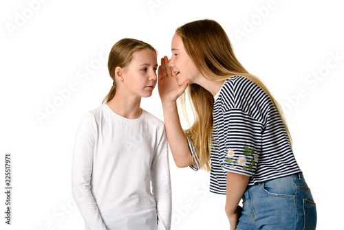 Young teen girls on white background whispering gossips