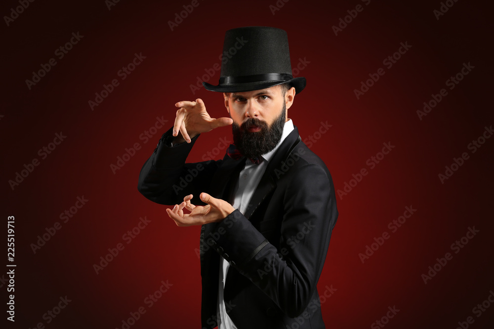 Magician showing tricks on dark background