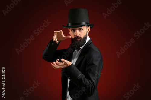 Tableau sur toile Magician showing tricks on dark background