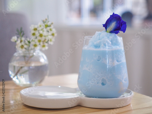 Blue smoothie with pea flower in a cafe. Blue milk shake. Healthy drinking. photo