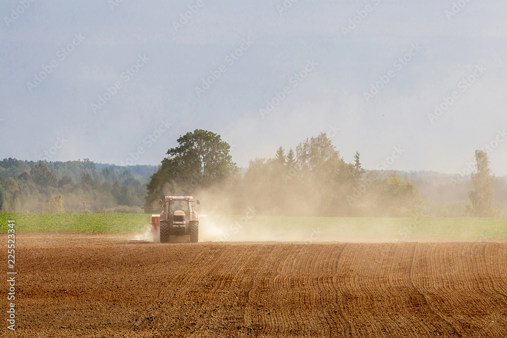Naklejka premium tractor handles land, very put