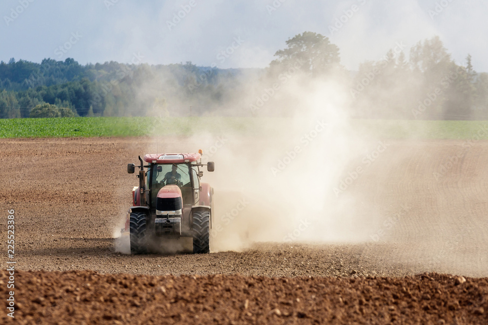 Naklejka premium tractor handles land, very put