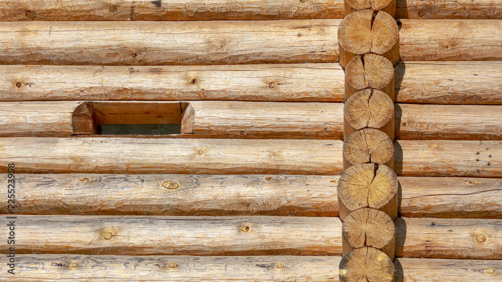 Wall with log house in the house as a background Wall with log house in the house as a background