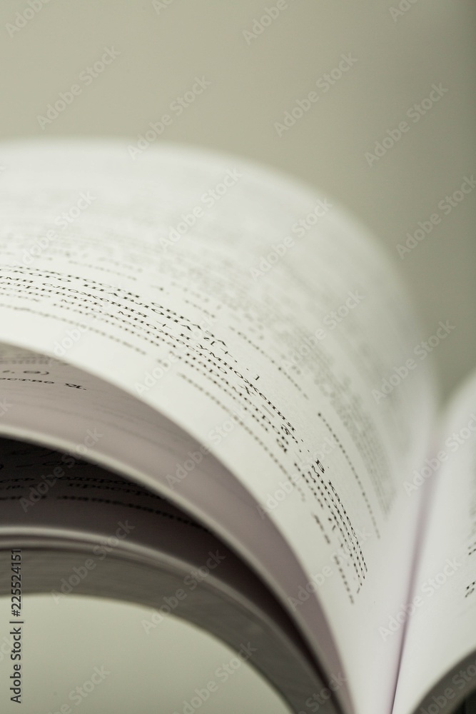 Open Book on the Grey Background - Close Up Open Book on the Grey Background - Close Up