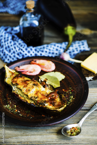 baked eggplant with cheese filling with shrimps on a plate