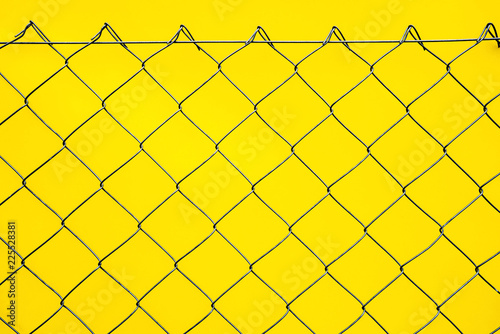 wire fence. seamless chain link fence. industrial fence on yellow background