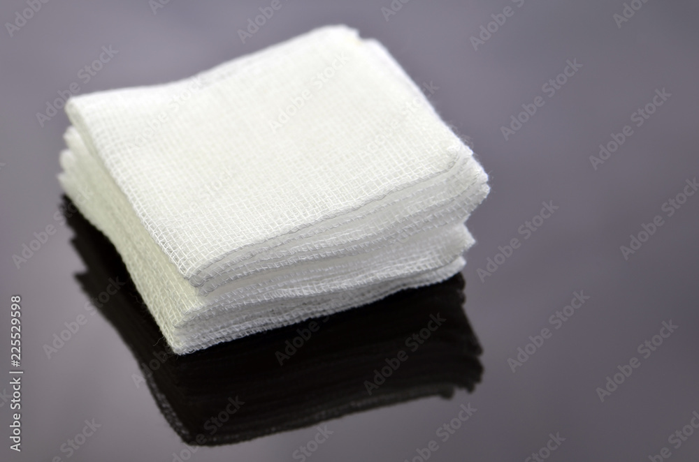Stack of sterile gauze pad on dark background. Stack of sterile gauze pad on dark background.