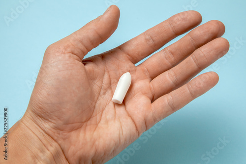 Suppository for anal or vaginal use in the hands of a man. Candles for treatment of hemorrhoids  temperature  thrush  inflammation