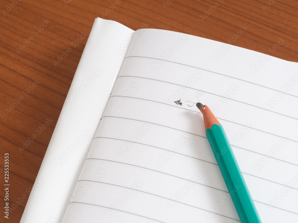 Broken pencil lead on blank lined paper. Stress or writers block. Broken pencil lead on blank lined paper. Stress or writers block.