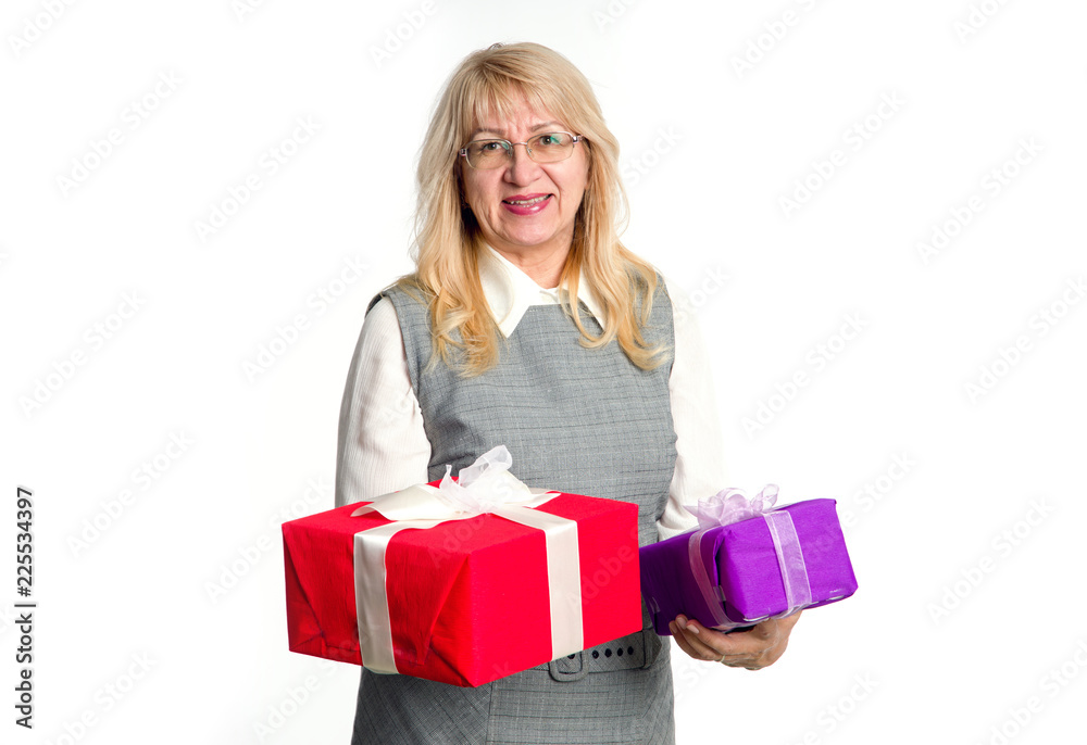 Senior woman with gifts boxes in her hands on a light background. Senior woman with gifts boxes in her hands on a light background.