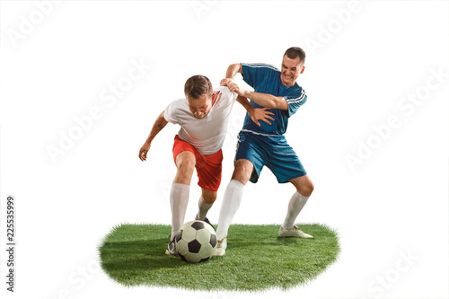 Football players tackling for the ball over white background. Professional football soccer players in motion isolated white studio background. Fit jumping men in action, jump, movement at game. © master1305