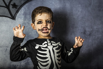 Little kid in a skeleton costume on Halloween Carnival
