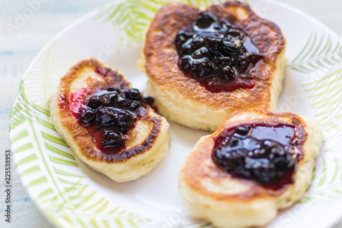 Pancakes are sprinkled with berry jam.