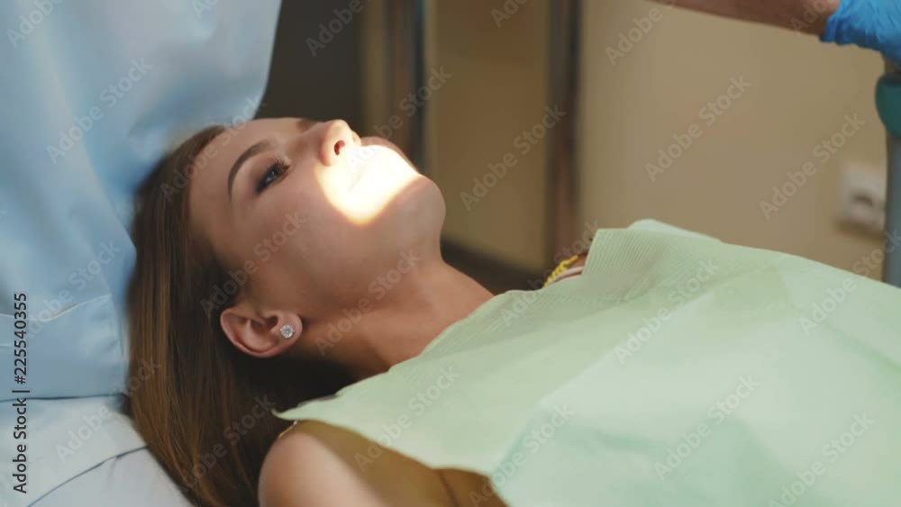 The girl is on dental treatment with special intraoral check. 4K