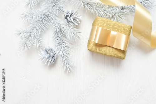 Mockup Christmas white tree, beige bow, gift box and cone. Flatlay on a white wooden background, with place for your text