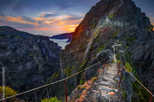 Madeira, Portugal. Hiking path between Pico do Arieiro and Pico do Ruivo at sunset above the clouds photo