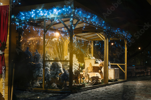 Stall in the Christmas market, selling Christmas trees and wooden objects in Warsaw, Poland