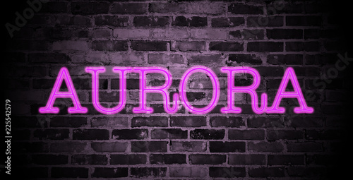 first name Aurora in pink neon on brick wall