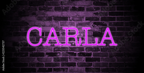 first name Carla in pink neon on brick wall