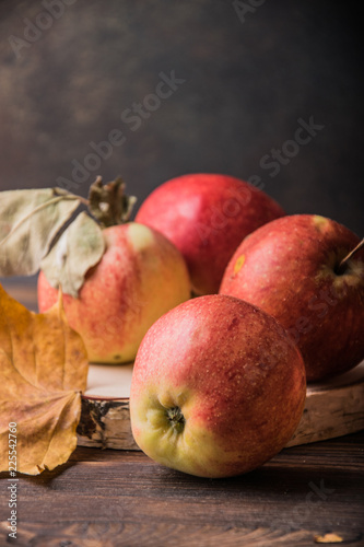 juicy and bright seasonal apples on a wooden table