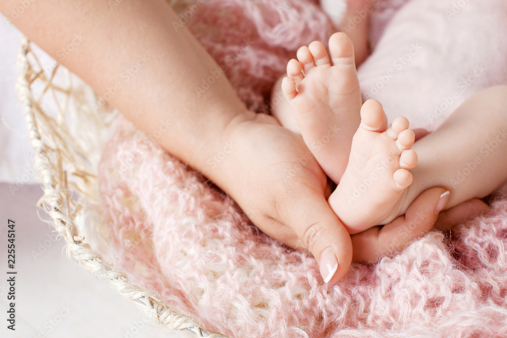 Baby feet in mother hands. Tiny newborn baby's feet on female hands closeup. Mom and her child. Happy Family concept. Beautiful conceptual image of parenthood Baby feet in mother hands. Tiny newborn baby's feet on female hands closeup. Mom and her child. Happy Family concept. Beautiful conceptual image of parenthood