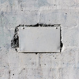 White metal plate on the old concrete wall