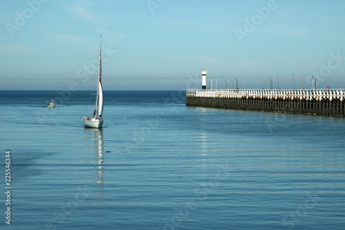 Sailboat in the port entrance of Nieuwpoort.  Belgium