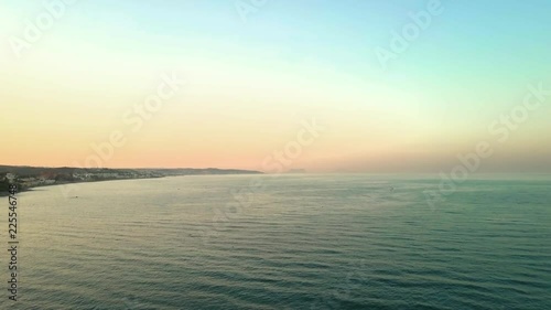AERIAL SHOT MOVING BACKWARDS. Bay area of Gibraltar on left with calm empty ocean on the left.
