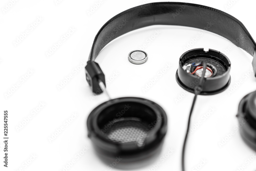 Broken earphones isolated on white background, Do it yourself or how to fix broken headphones concepts. Broken earphones isolated on white background, Do it yourself or how to fix broken headphones concepts.