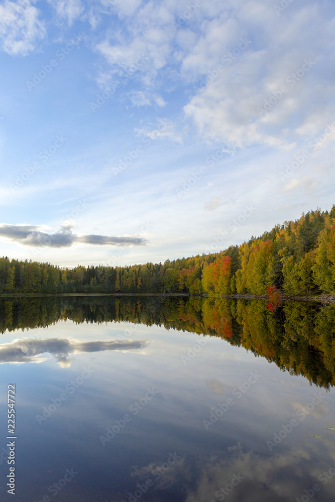 Wallpaper image from autumnal Finland. Reflecting waters with colorful forest.