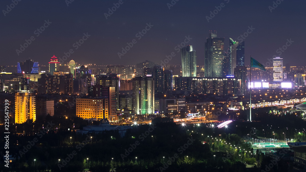 Elevated night view over the city center and central business district with bayterek Timelapse, Kazakhstan, Astana