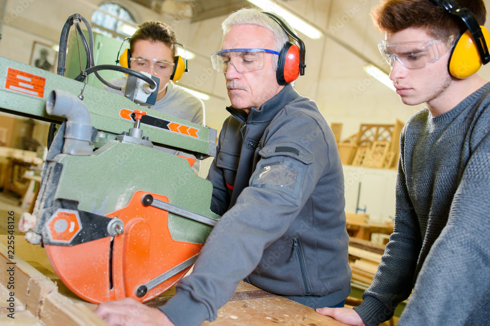 Students learning how to use large circular saw Students learning how to use large circular saw