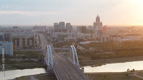 Sunset timelapse above the Bridge with the transport and clouds on the background. Central Asia, Kazakhstan, Astana photo