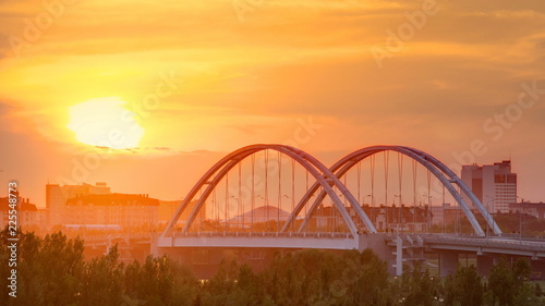 Sunset timelapse above the Bridge with the transport and clouds on the background. Central Asia, Kazakhstan, Astana